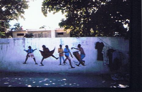 Street mural of people dancing in celebration of Aristide’s victory