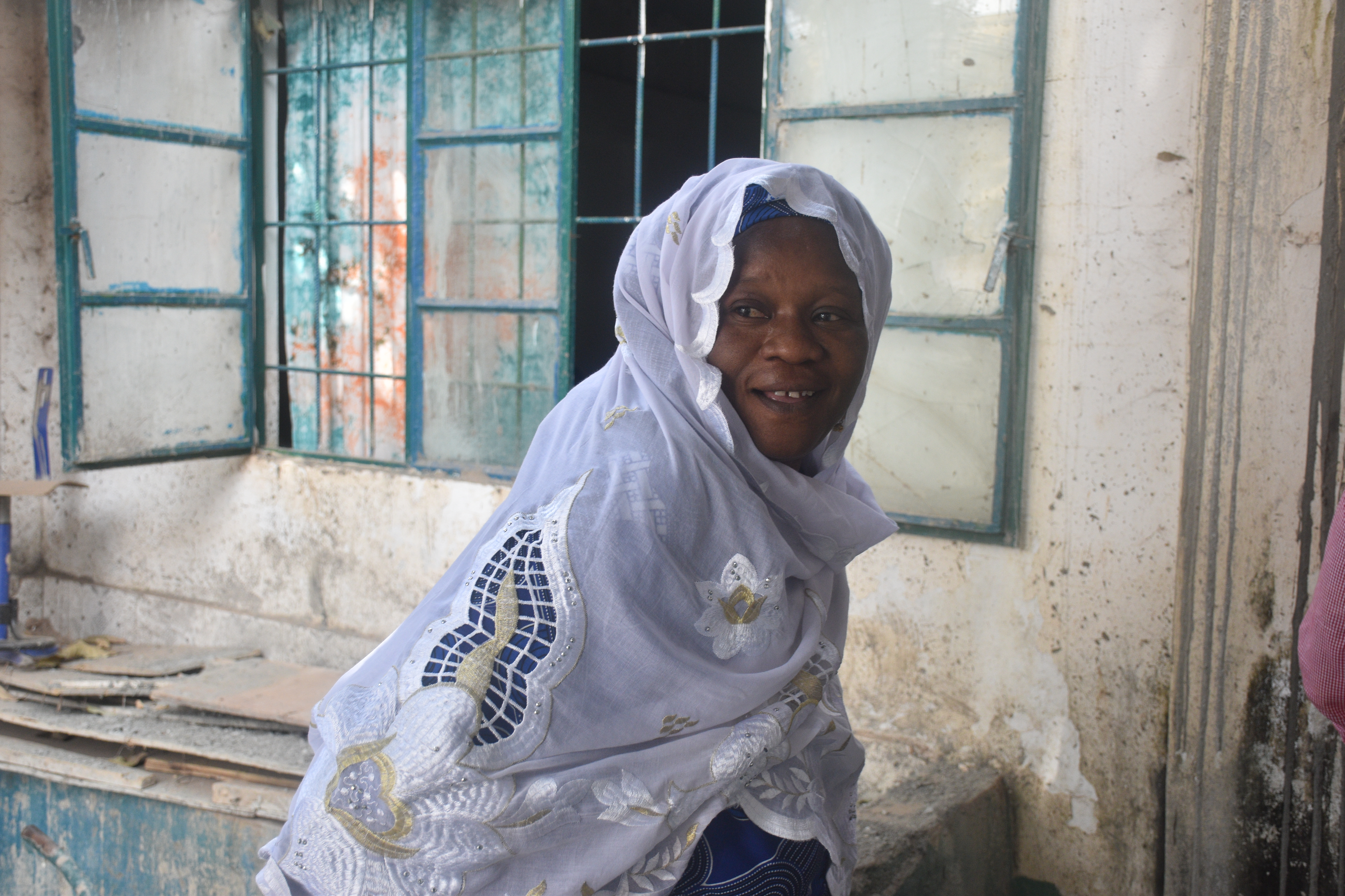 Amie Jatta Njie, a community activist who campaigns against FGM in The Gambia, outside the school she founded in the capital, Banjul on 13 February 2025. Credit: Alistair Scrutton, International IDEA